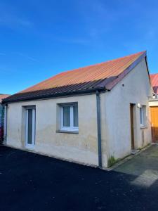 a house with a rusty tin roof on a street at Eiffel in Haubourdin