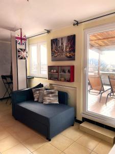 a living room with a couch and a window at Attico Sant'Anna - Silent Bay Apartments in Sestri Levante