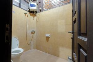a bathroom with a toilet and a shower at RedDoorz @ Cilandak Timur in Jakarta