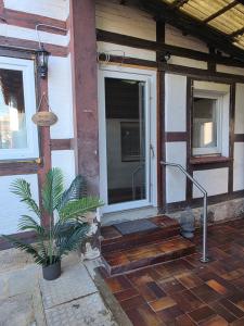 a porch of a house with a potted plant at Unter den Balken - mit Ofen & Ruhe Keine Monteure! in Nörten-Hardenberg