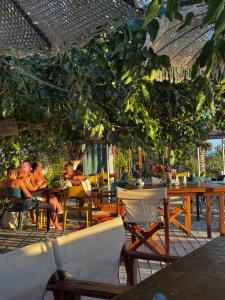 a group of people sitting at tables in a restaurant at Kallmi View - Nature Retreat on the Albanian Adriatic Coast in Durrës