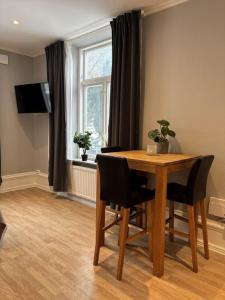 a dining room table with chairs and a window at Villa Bäckagård Bed and Breakfast in Åstorp