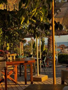 a table and chairs on the beach under an umbrella at Kallmi View - Nature Retreat on the Albanian Adriatic Coast in Durrës