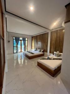 two beds in a large room with marble floors at Views Backpackers Hostel in Nongkhiaw +44 photos