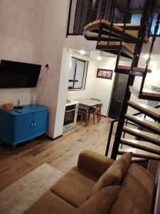 a living room with a couch and a dining room at Davit batoni Apartment in Mtskheta in Mtskheta