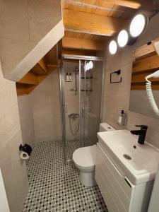 a bathroom with a shower and a toilet and a sink at Macaron The Pure Guest Houses in Ayvalık