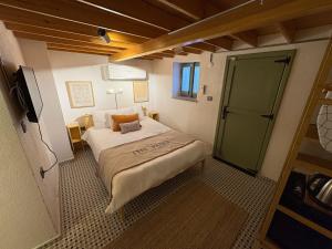 a small room with a bed and a sliding door at Macaron The Pure Guest Houses in Ayvalık