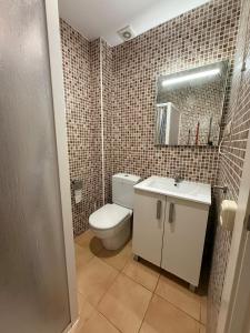 a bathroom with a toilet and a sink and a mirror at Casa de Mar in Lloret de Mar +3 photos