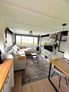 a living room with a couch and a table at De Polderhoeve in Heerhugowaard