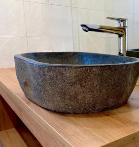 a stone sink sitting on top of a wooden counter at Dolomites Chalet CESA VEDLA -nature & silence in Ortisei +80 photos