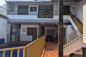 a view of a building with stairs and a balcony at Hotel Pisci Stars Sra in Saravena +10 photos
