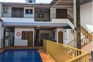 a house with a swimming pool and a balcony at Hotel Pisci Stars Sra in Saravena