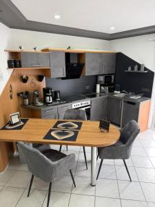 a kitchen with a wooden table and chairs at Ferienwohnung Pellenz in Bremm