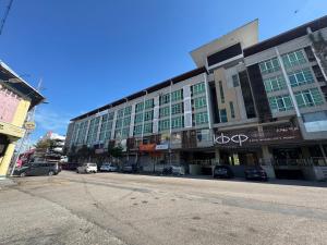 a building on a street with cars parked in front of it at EasyStay Studio Apartment KBCP in Kota Bharu +22 photos