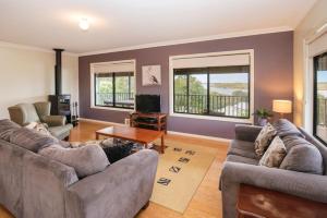 a living room with two couches and a table at Waterside View in Augusta