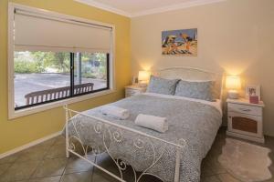 a bedroom with a bed and a large window at Waterside View in Augusta
