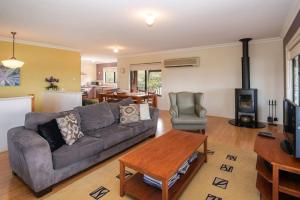 a living room with a couch and a table at Waterside View in Augusta +5 photos