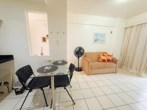 a living room with a table and a couch at Biarritz praia in São Luís