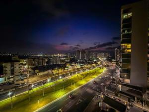 a city street at night with cars on the road at Biarritz praia in São Luís