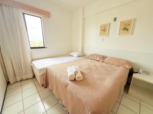 a bedroom with two beds with towels on them at Biarritz praia in São Luís