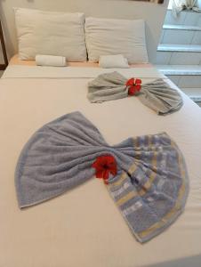 two mens bow ties on a bed at Hospedagem Terral Beach Canoa Quebrada in Aracati +30 photos