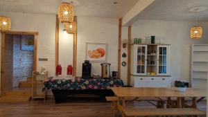 a restaurant with a table and two tables and chairs at Shambhala in Czarnów +5 photos