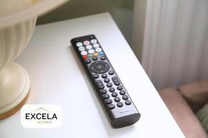 a remote control sitting on top of a table at Modern Airport Annexe - Free Parking - Sleeps 4 - Near Luton Airport in Luton +7 photos