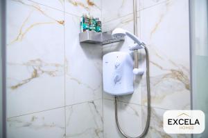 a shower in a bathroom with a soap dispenser on a wall at Modern Airport Annexe - Free Parking - Sleeps 4 - Near Luton Airport in Luton