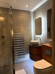 a bathroom with a toilet and a sink at Were House Warminster in Warminster +17 photos