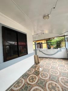 a room with a large window and a mosaic floor at Triple K Transient House in Butuan