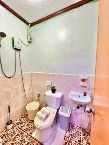 a bathroom with a toilet and a sink at Triple K Transient House in Butuan +9 photos