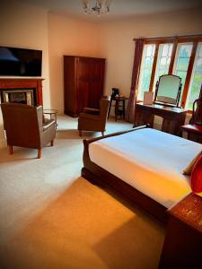 a bedroom with a large bed and a fireplace at Swan Hotel Forton in Forton