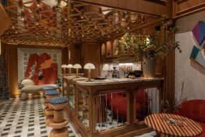 a kitchen with a bar with a table and chairs at Maison DADA in Beirut