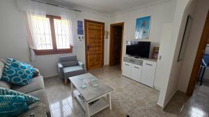 a living room with a couch and a table at Villa Nina in Mazarrón