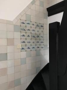 a bathroom with blue and white tiles on a wall at De Kleine Prins Enkhuizen in Enkhuizen