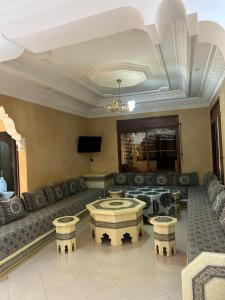a large living room with a couch and a table at chitoui in Ben Slimane