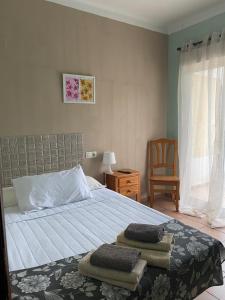 a bedroom with a bed with two towels on it at Hotel Move Espadan in Azuébar