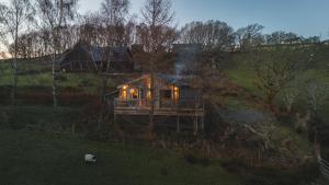 a house sitting on top of a hill with lights at Eagle's Nest Connemara and Westport in Westport