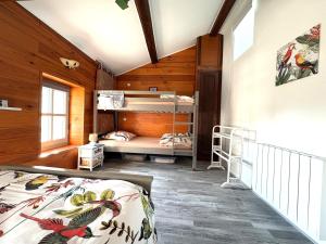 a bedroom with two bunk beds in a cabin at Gîte des oiseaux in Préchac