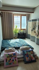 a bedroom with a large bed with a quilt on it at Hanyang Healing House - 외국인 전용 in Seoul
