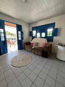 a living room with a couch and a table at Canto da Ita - Próxima a praia com piscina e churrasqueira in Itamaracá +18 photos