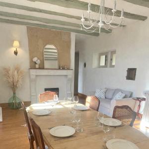 a dining room with a table and a fireplace at Le Petit Manoir avec Piscine Privée in Le Bugue