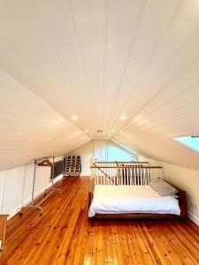 a bedroom with a bed in a room with wood floors at Cosy stay within South Downs! in Southampton
