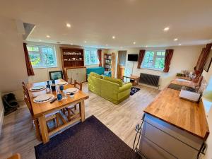 a living room with a table and a green couch at Cosy stay within South Downs! in Southampton