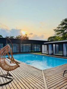 a chair sitting on a deck next to a swimming pool at The Legacy Hotel and Spa in Tzaneen