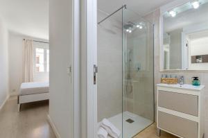 a bathroom with a glass shower with a sink at YourHouse Llimonera in Port de Pollensa +36 photos