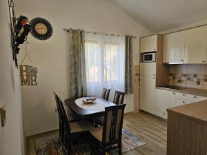 a kitchen and dining room with a table and chairs at Apartments Nadja in Kotor