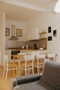 a kitchen with a table and chairs in a room at La Loggia Del Popolo in Ascoli Piceno