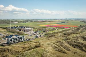 an aerial view of a parking lot with red tulips at Residence Westduin in Sint Maartensvlotbrug