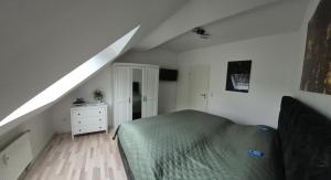 a bedroom with a bed and a white dresser at Casa-Mandelartz in Rees
